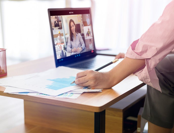 Image of a young woman watching a video on her computer